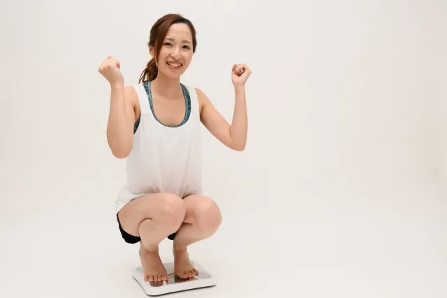 疲労回復して元気なポーズをする女性の写真です。